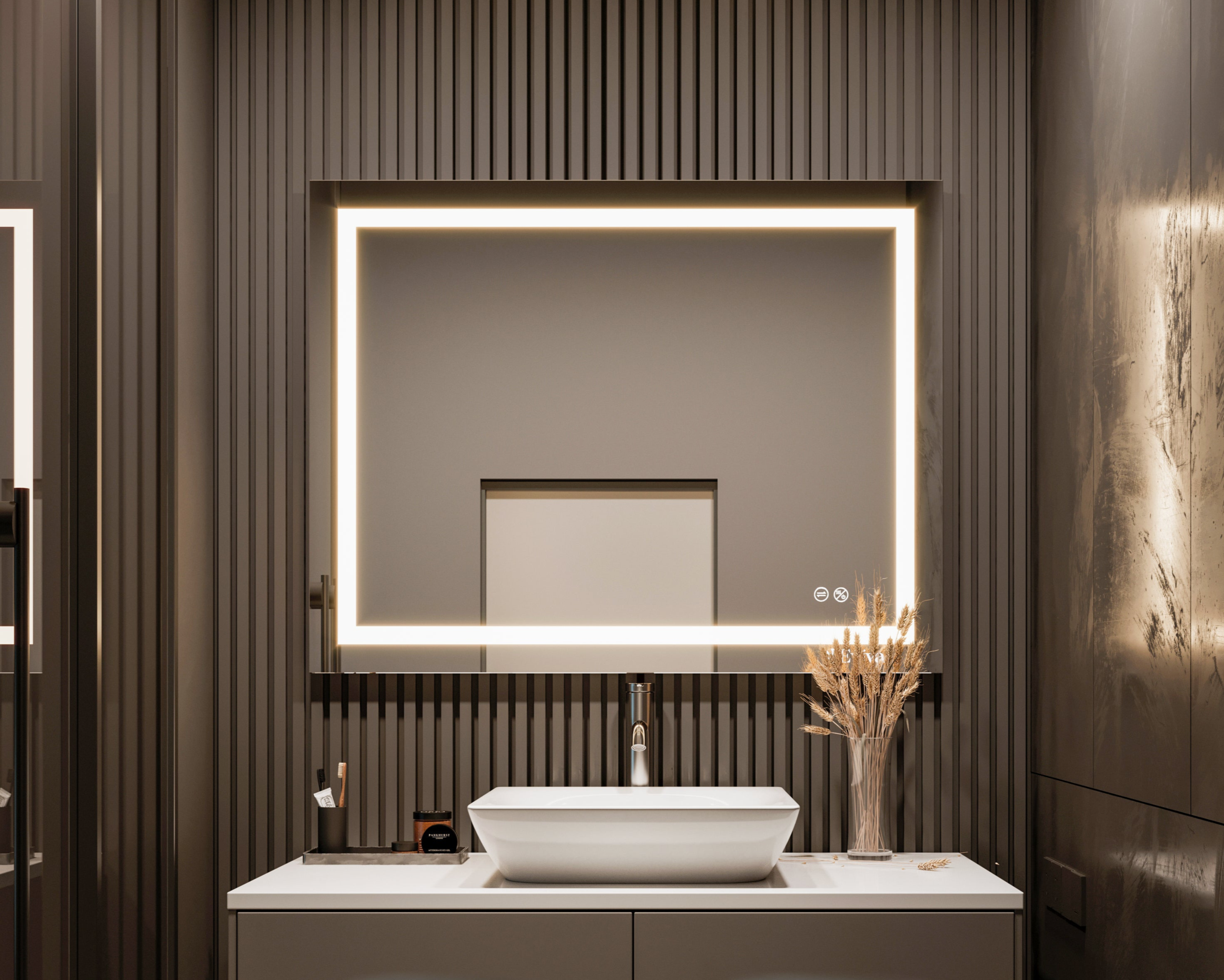 Bathroom mirror with warm light above a modern white vessel sink and gray vanity showing a small decorative vase with dried wheat