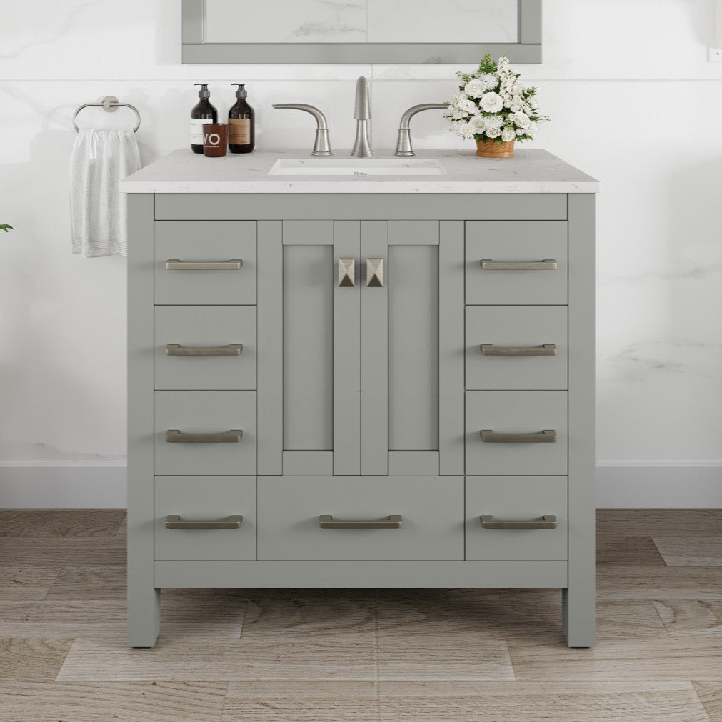 A gray single sink bath vanity with a Carrara quartz top and undermount porcelain sink, featuring stainless steel brushed nickel hardware.