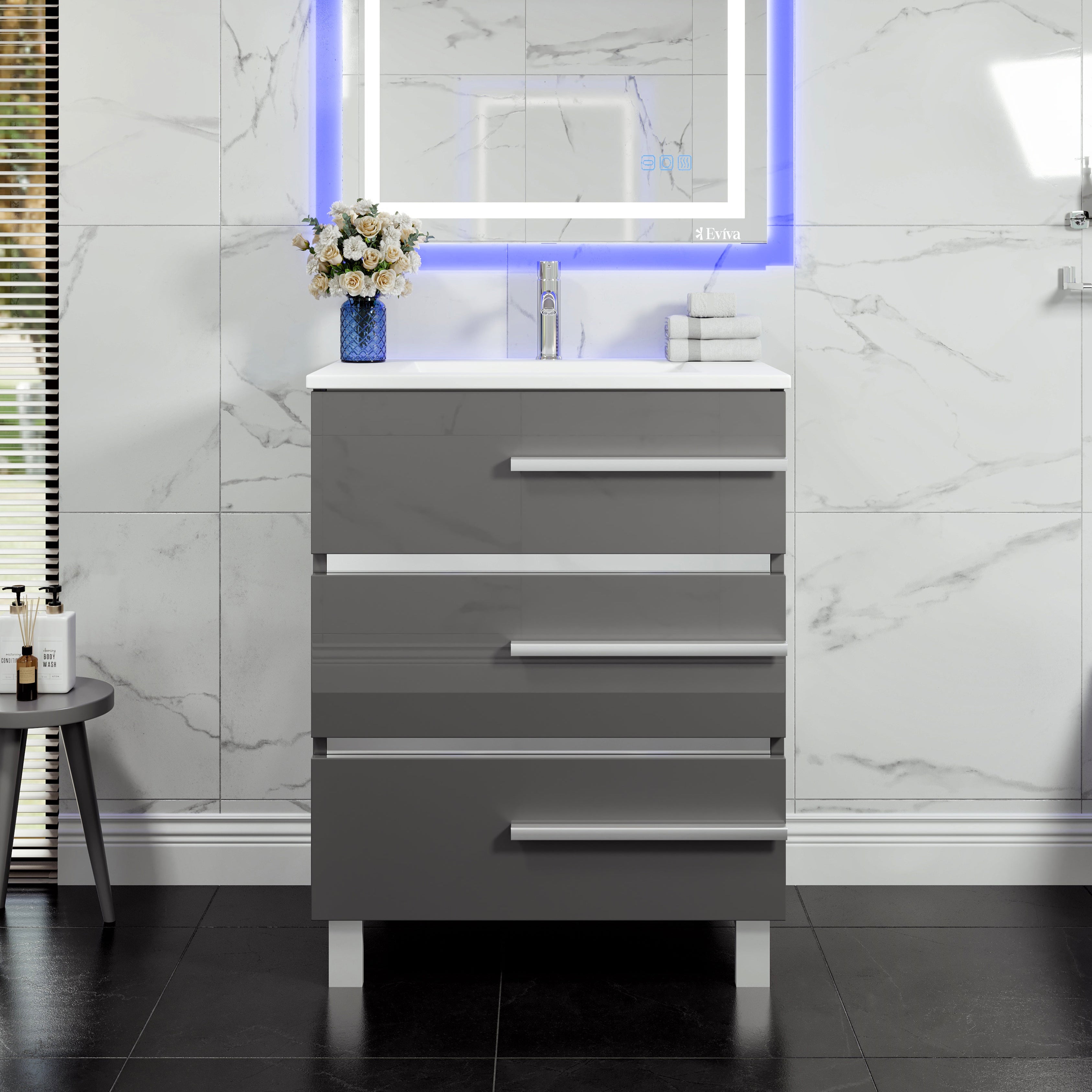 A modern gray bathroom vanity with white porcelain countertop and integrated sink, featuring stainless steel hardware and three drawers.
