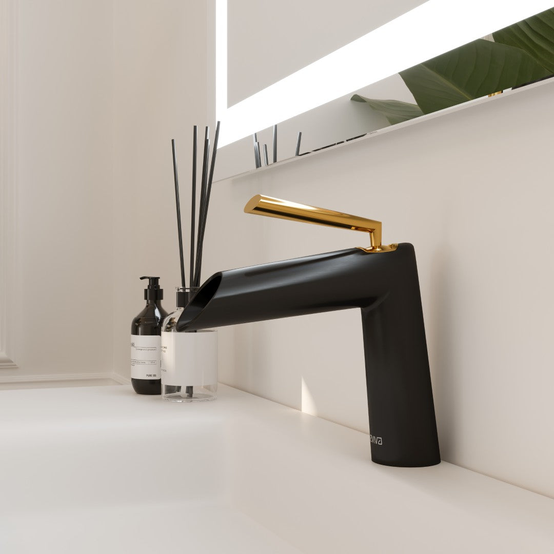 Eviva Black and gold waterfall bathtub faucet filling a tub.