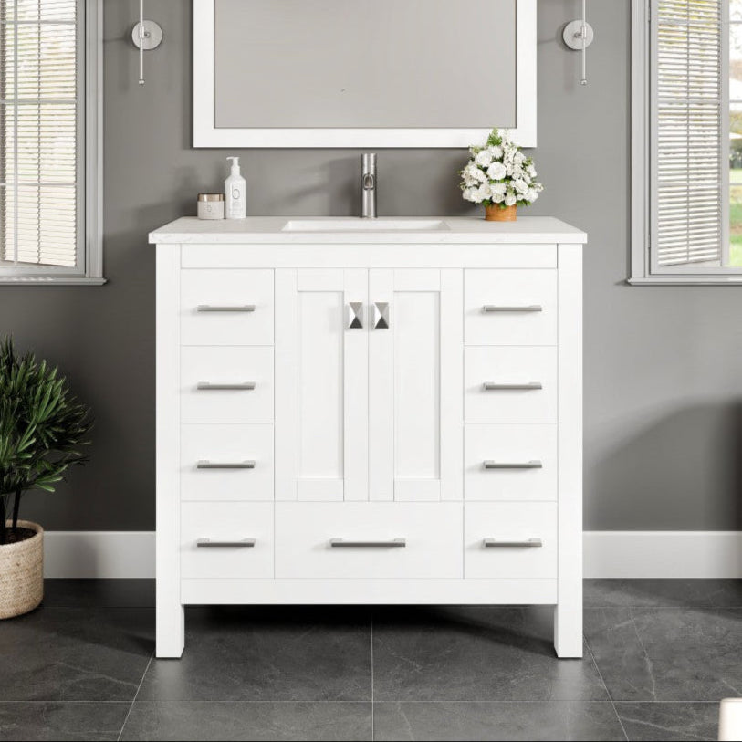 A white single sink bath vanity with a Carrara quartz top and undermount porcelain sink, displayed in a bathroom setting with a mirror above it.