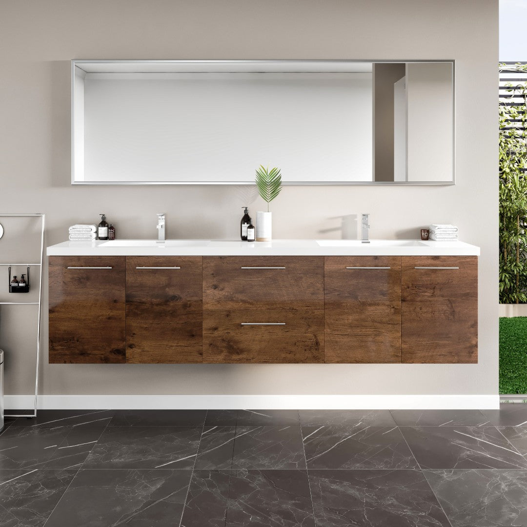 A wall-mounted double sink bath vanity with rosewood finish and acrylic top, featuring integrated sinks and chrome handles, displayed in a bathroom setting.