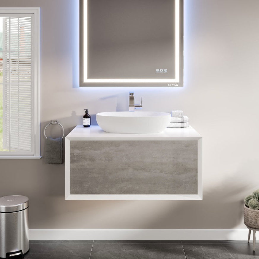 A modern Santa Monica 36 inch gray wall mount single sink bath vanity with an acrylic top and a vessel solid surface sink, displayed in a bathroom setting with a mirror above the vanity and a plant to the side.