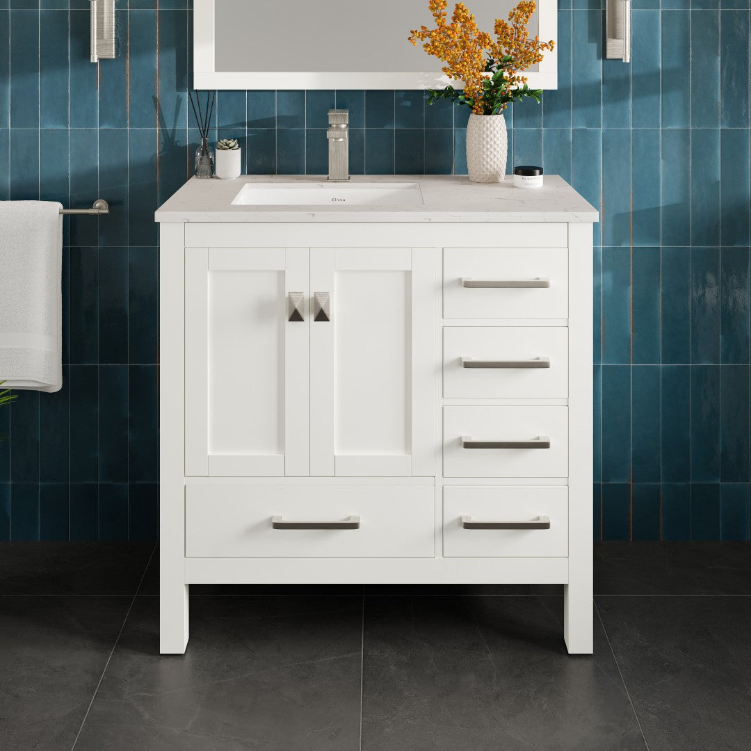 A white single sink bath vanity with a Carrara quartz top and undermount porcelain sink, featuring a white finish, wooden cabinet, and brushed nickel hardware.
