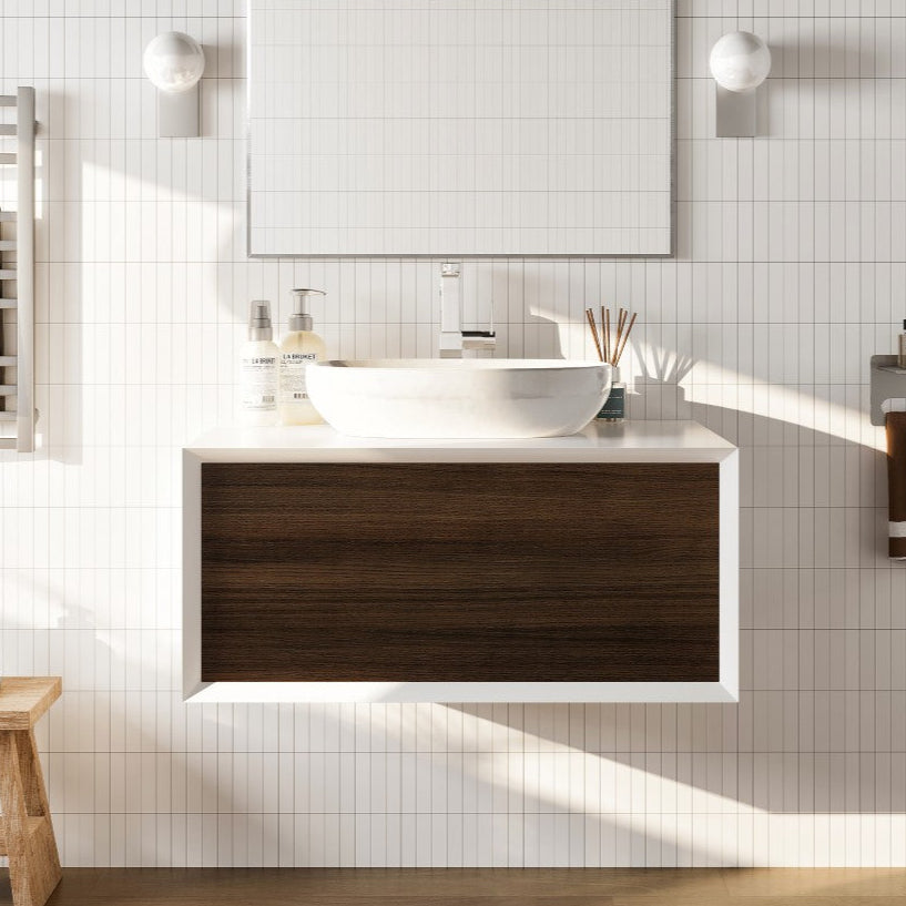 A modern Santa Monica 36 in. gray oak wall mount single sink bath vanity with an acrylic top and solid surface vessel sink, displayed in a bathroom setting with wall lights and a mirror above the vanity.