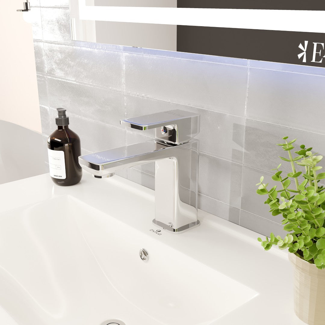 A modern single-handle bathroom faucet with a waterfall spout, installed on a sink, with a chrome finish.