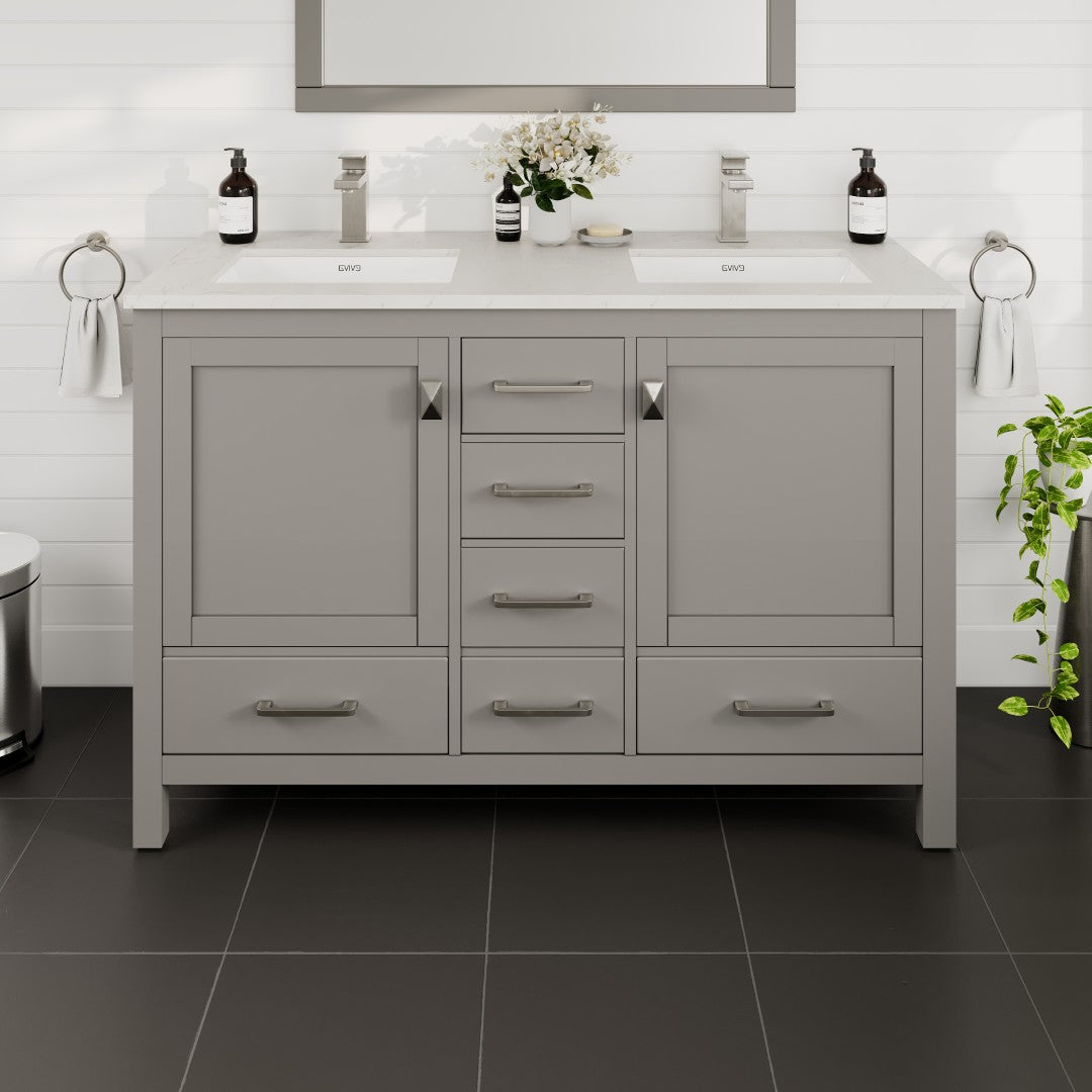 A gray double sink bath vanity with a Carrara quartz top, undermount porcelain sinks, and brushed nickel hardware.
