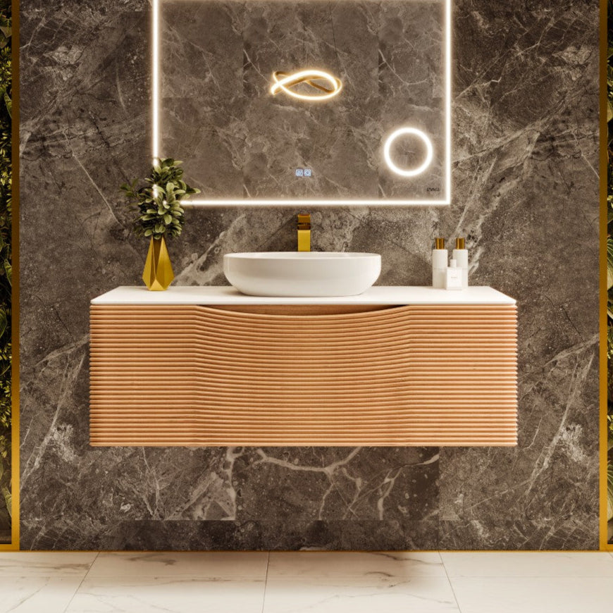 A contemporary medium oak wall mount vanity with a solid surface top and vessel sink, featuring a wavy geometric design, mounted on a marble wall with gold accents.