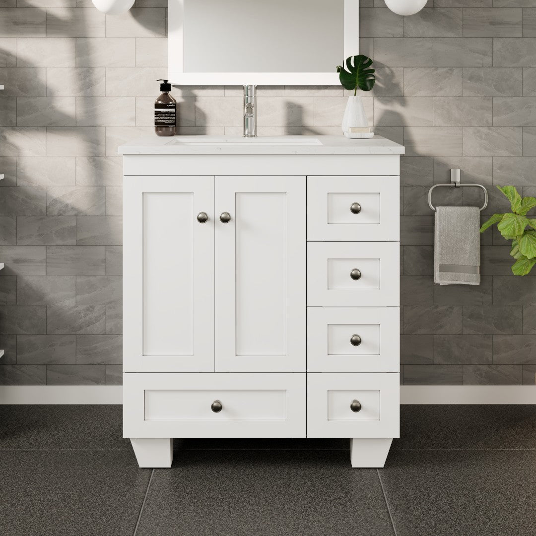 A white single sink bath vanity with a Carrara quartz top and undermount porcelain sink, featuring a white finish, wooden drawers and doors, and brushed nickel hardware.