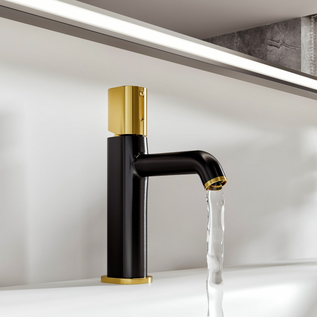 A single-handle straight single-hole bathroom faucet with a gold handle and spout tip, in matte black, with water flowing from the spout.