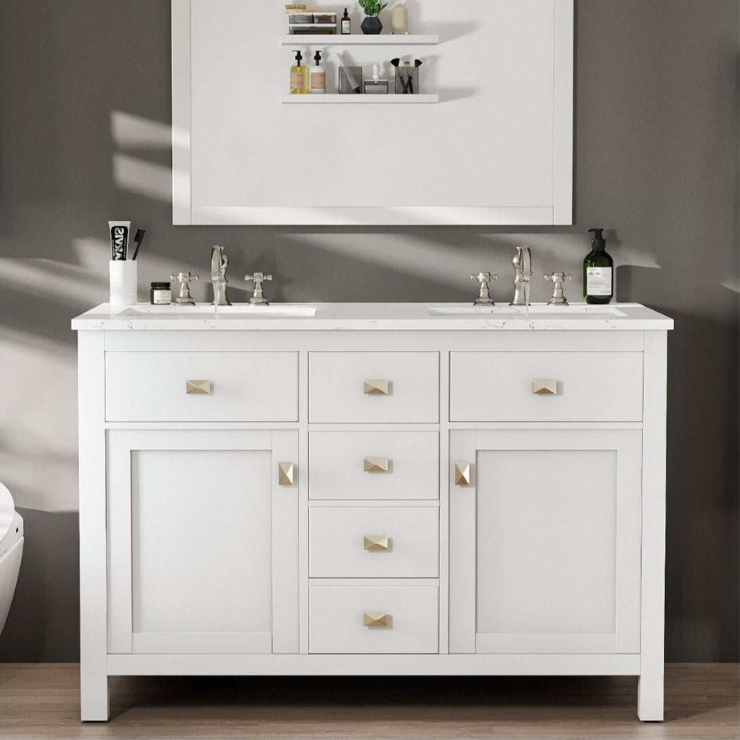 A white double sink bathroom vanity with engineered top and undermount porcelain sinks, featuring a mirror above and brushed nickel hardware.