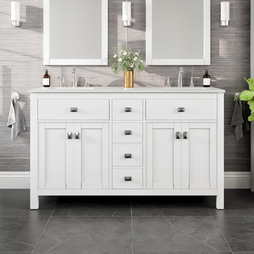 A white double sink bathroom vanity with a Carrara quartz top, undermount porcelain sinks, and silver handles, displayed in a bathroom setting.