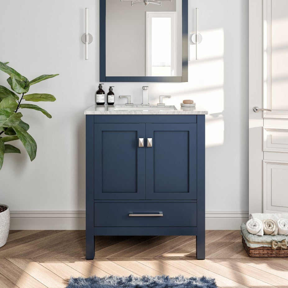 Bathroom with a blue vanity, mirror, and decorative items.
