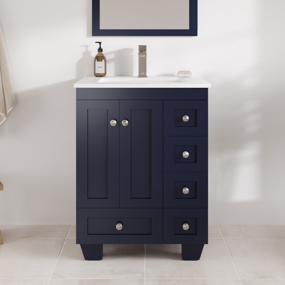 Navy blue bathroom vanity with white countertop in a bathroom setting.