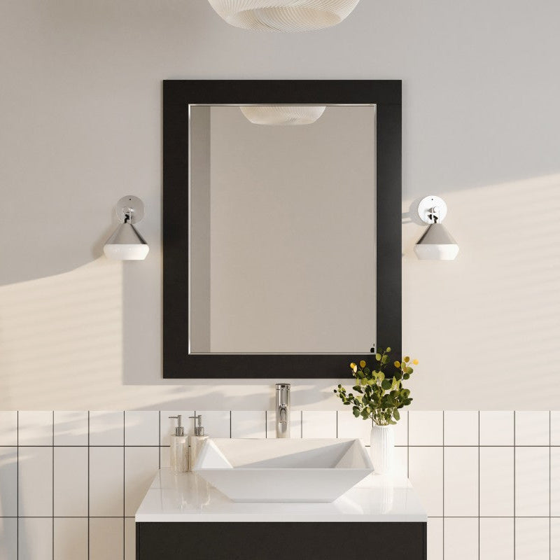 A rectangular espresso wooden framed mirror mounted above a bathroom sink and vanity.