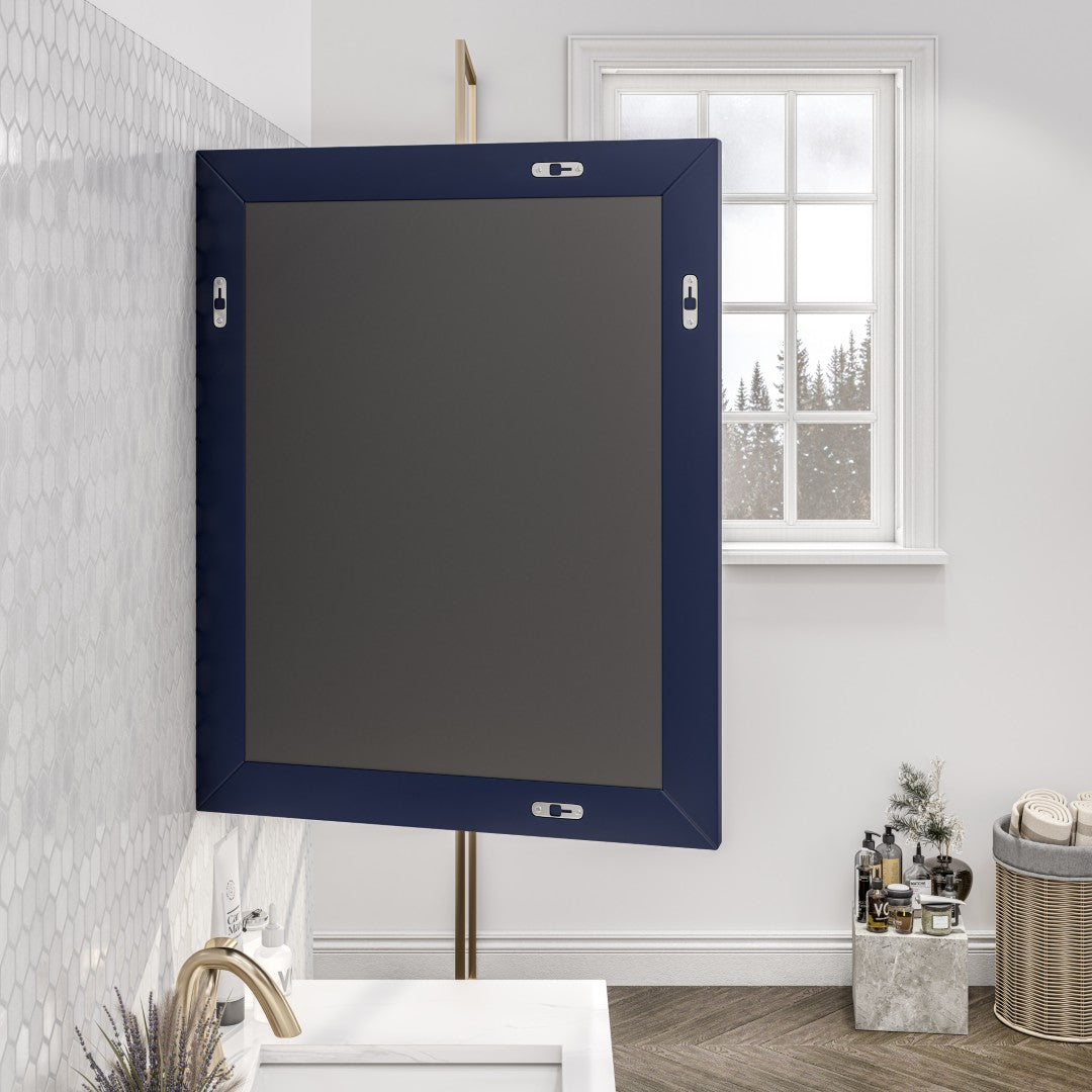 Back of a square, dark blue framed mirror hangs on a light-colored wall with vanity