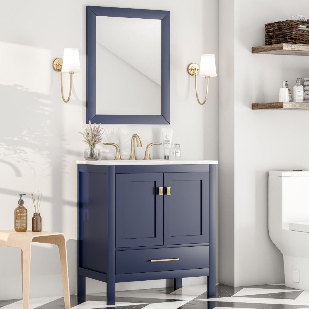 A square, dark blue framed mirror hangs on a light-colored wall with blue vanity