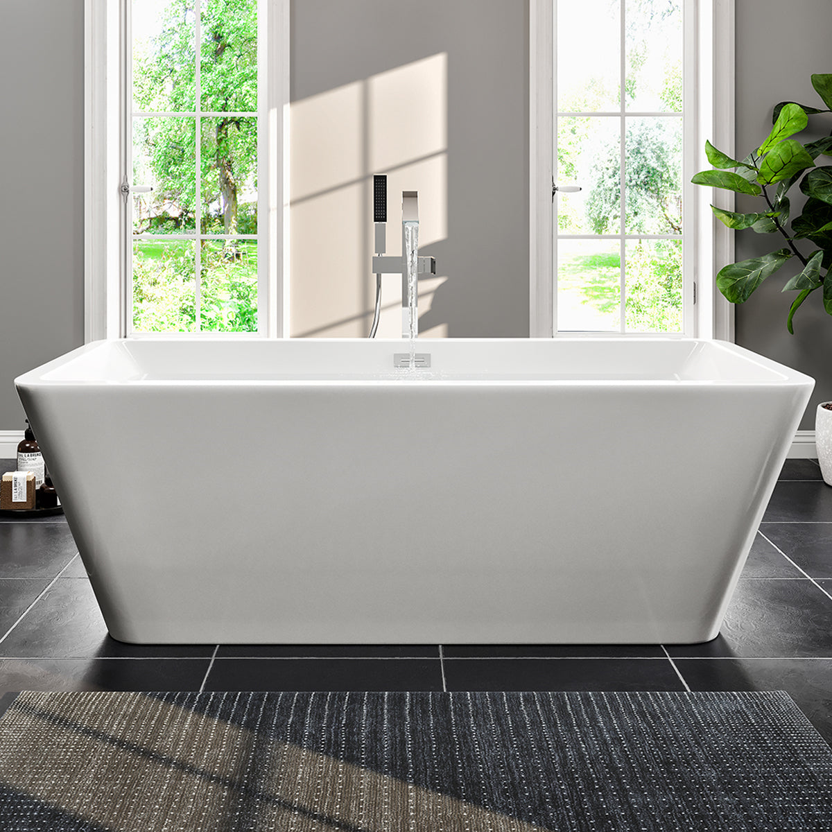 A glossy white acrylic freestanding bathtub with curved edges, placed in a room with a light interior and a large window.