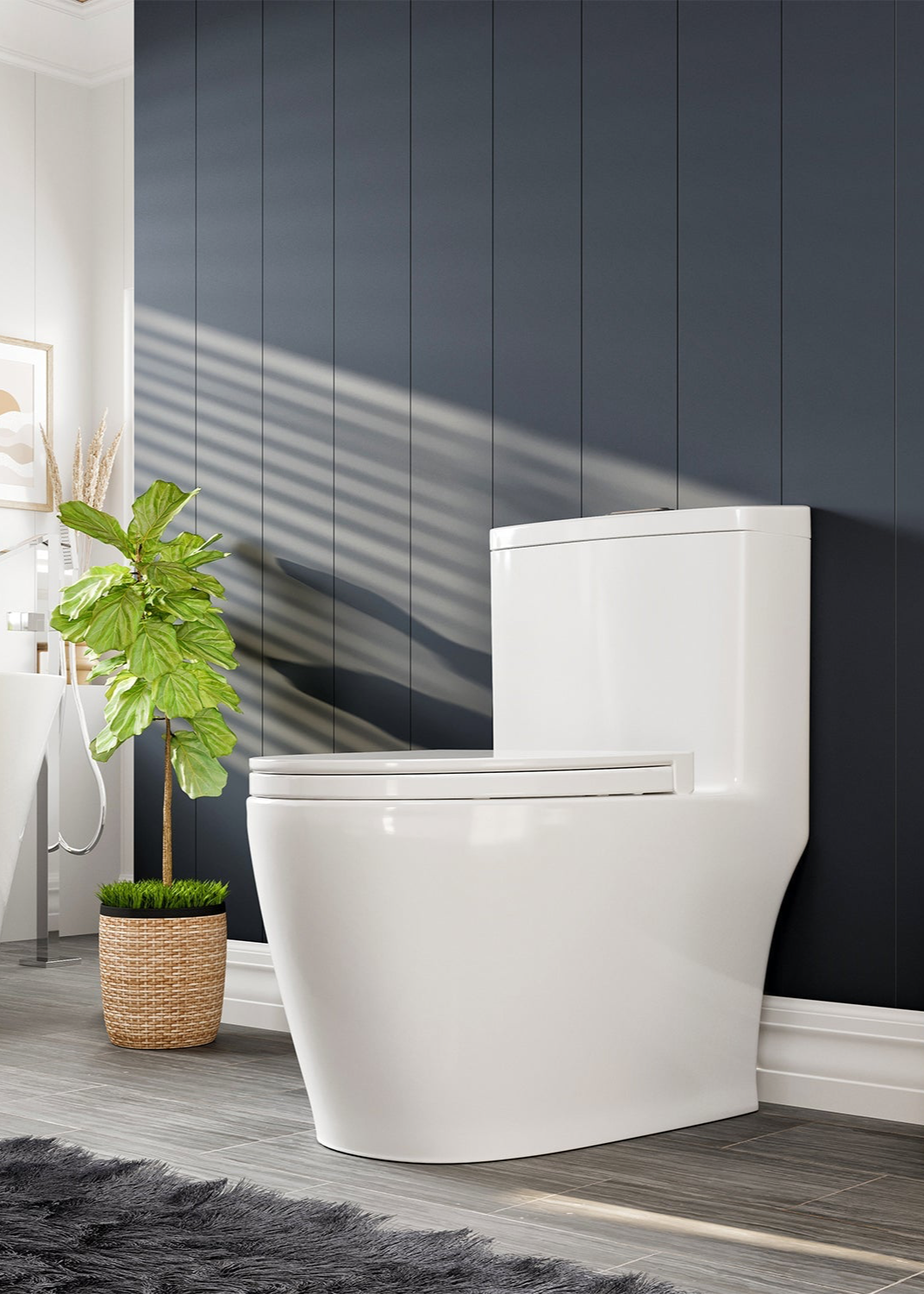Modern white toilet against a gray paneled wall, with a potted plant beside it and sunlight