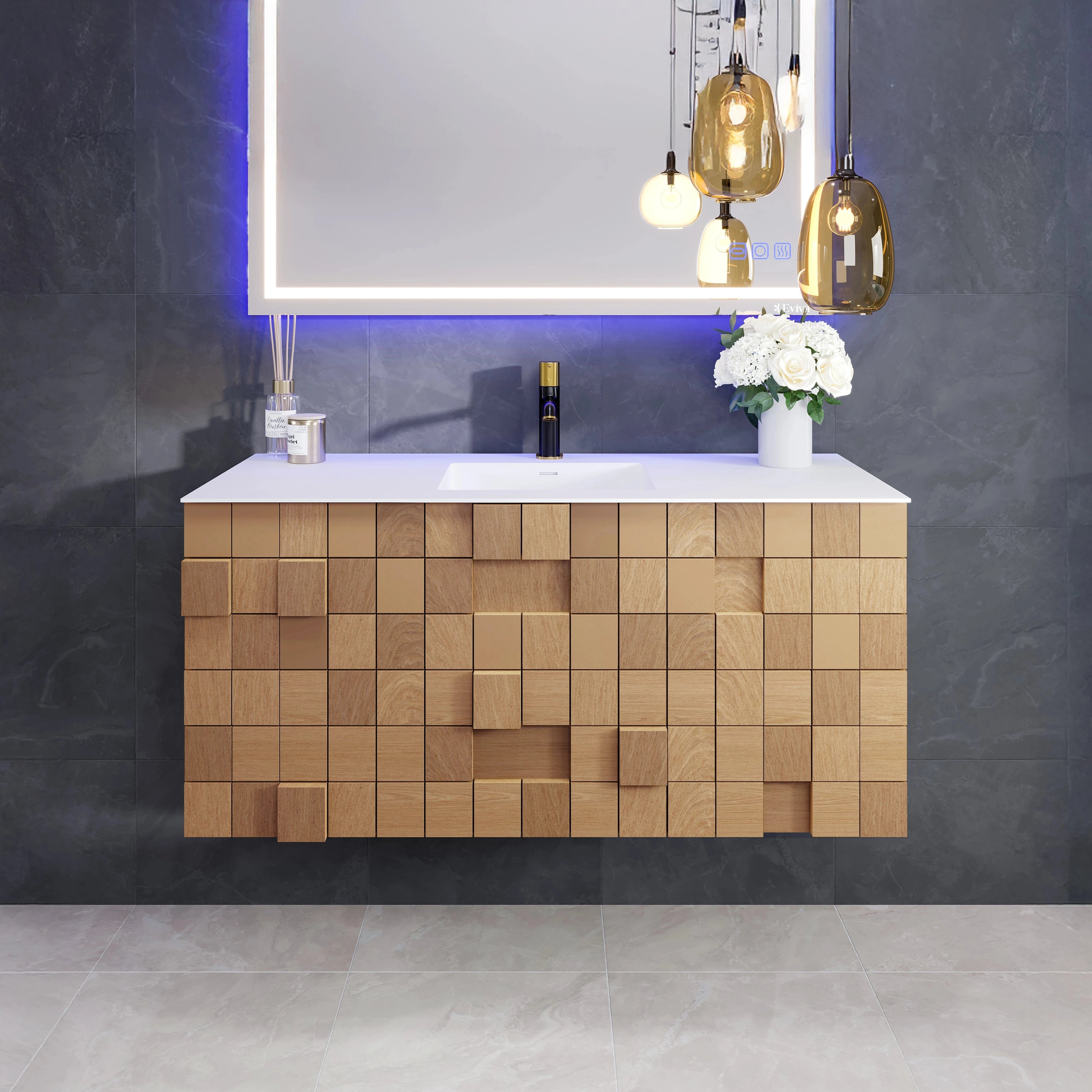 A modern wall-mounted single sink bath vanity with a natural oak finish and a solid surface top, featuring an integrated sink and two soft-closing drawers, illuminated by a hanging light fixture.