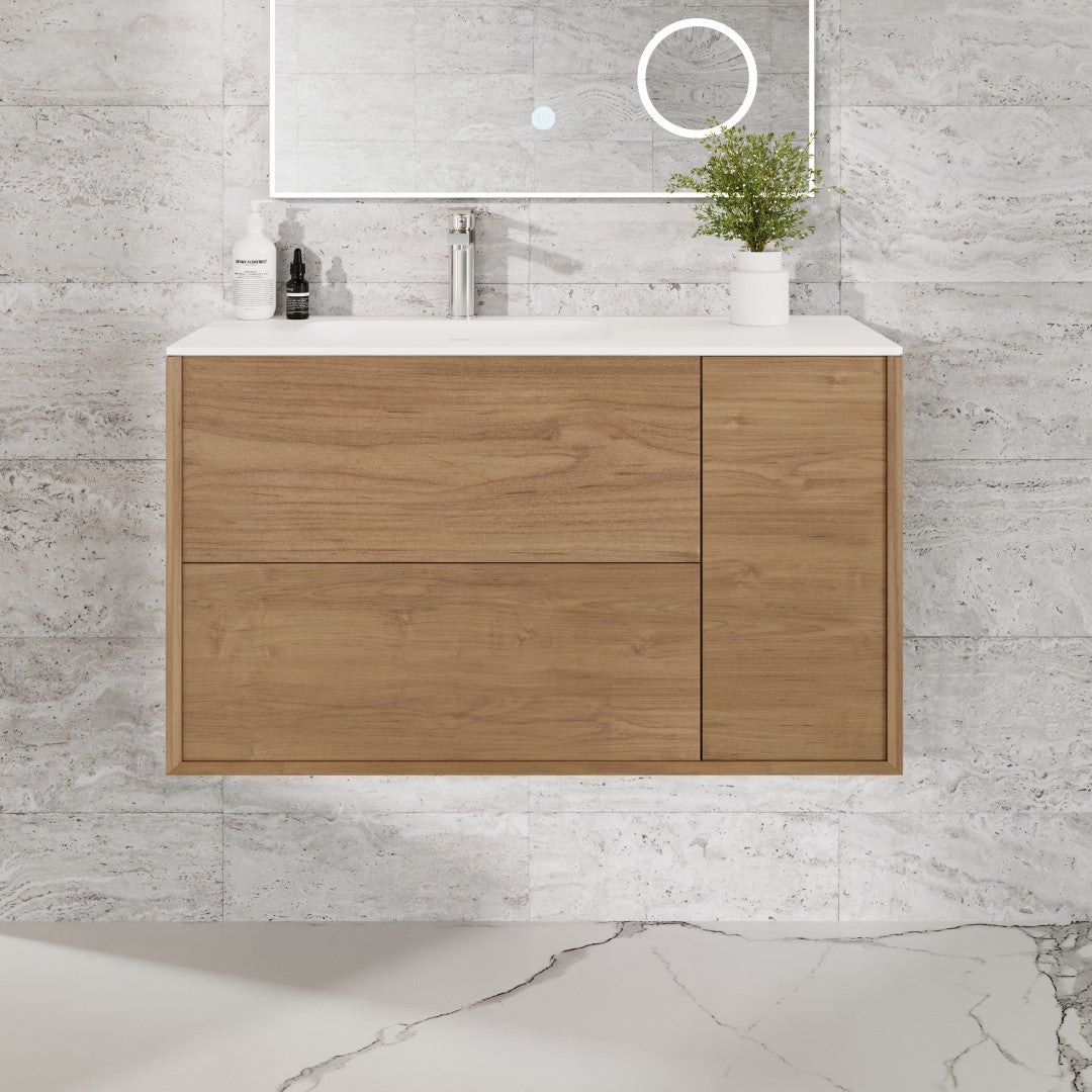 A natural oak wall mount single sink bath vanity with a solid surface top and integrated sink, displayed against a white marble background.