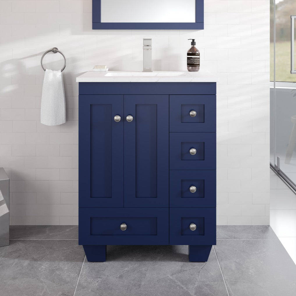 A blue single sink bath vanity with a white Carrara Quartz countertop and undermount porcelain sink, featuring stainless steel brushed nickel hardware, soft-closing drawers, and a mirror above.