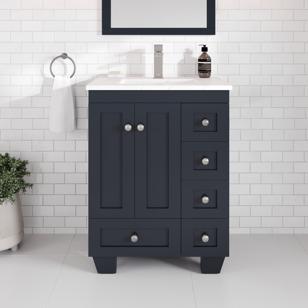 A dark gray single sink bath vanity with a Carrara quartz top, undermount porcelain sink, and stainless steel brushed nickel hardware, against a white tiled wall.