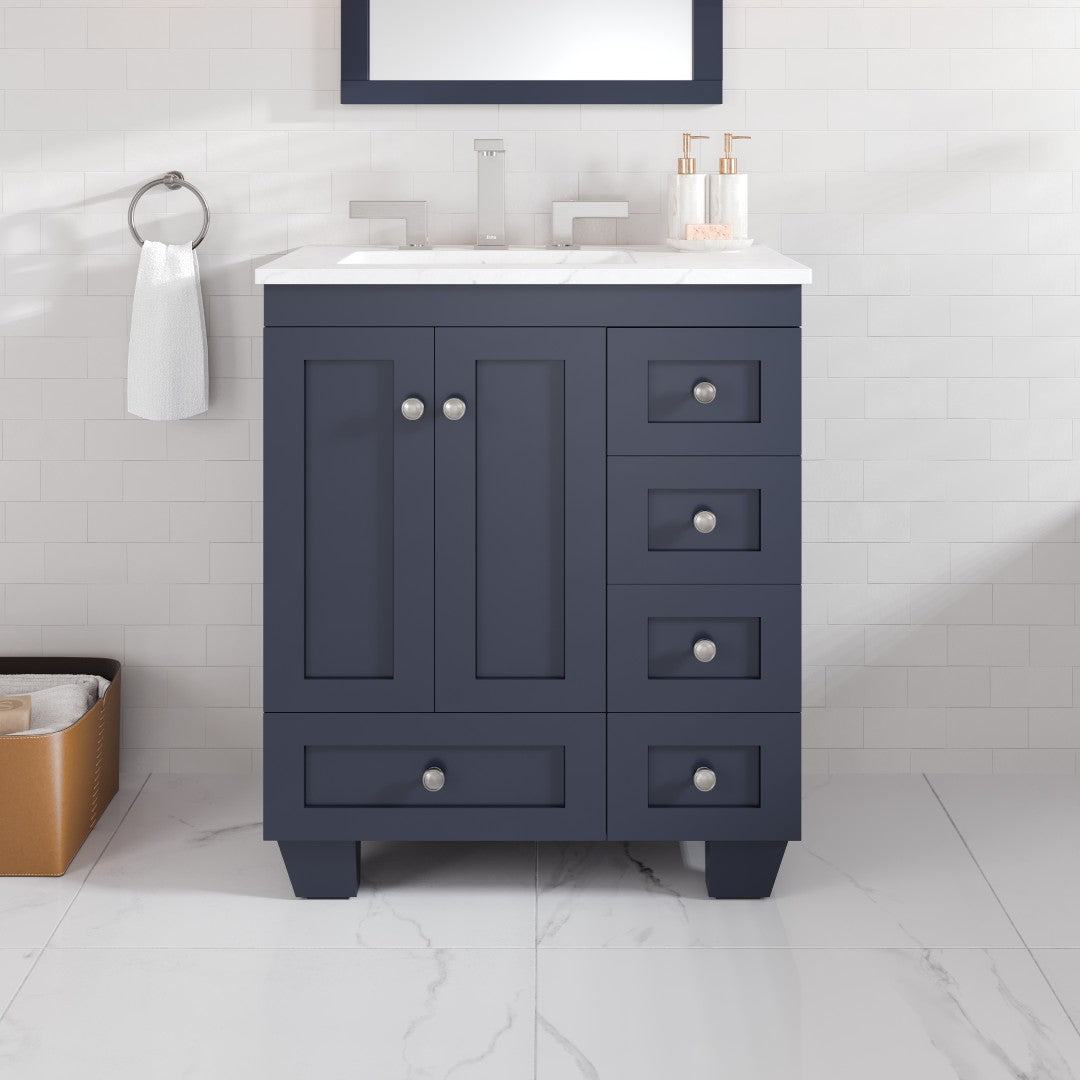A dark gray single sink bath vanity with a Carrara quartz top and undermount porcelain sink, featuring a mirror above and brushed nickel hardware.