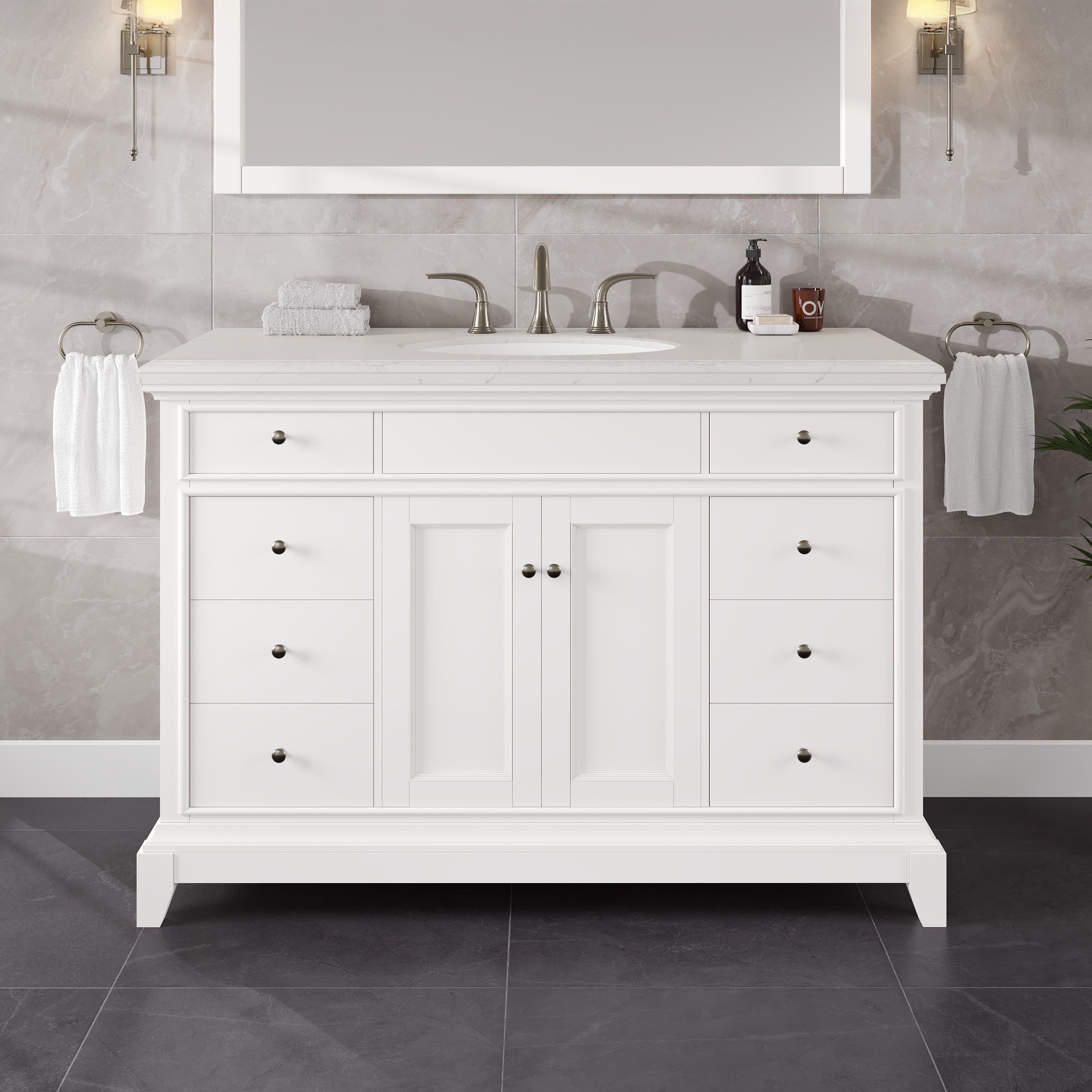 A white bathroom vanity with a quartz countertop, featuring a porcelain sink and mirrored medicine cabinets.