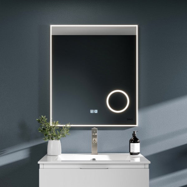 A modern rectangular LED bathroom mirror with a chrome aluminum frame, displayed above a white vanity with drawers.