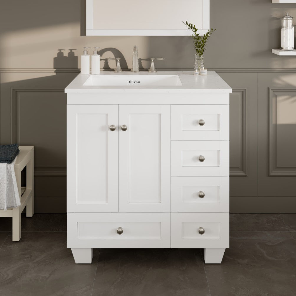 A white single sink bath vanity with a Carrara quartz top and undermount porcelain sink, featuring silver brushed nickel hardware, two doors, and five drawers.