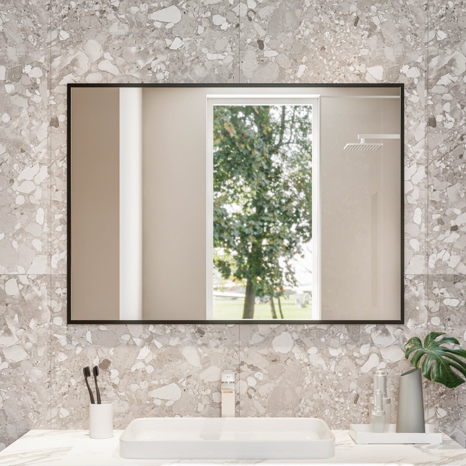 Bathroom vanity with marble countertop, mirror, and decorative items against a textured wall.