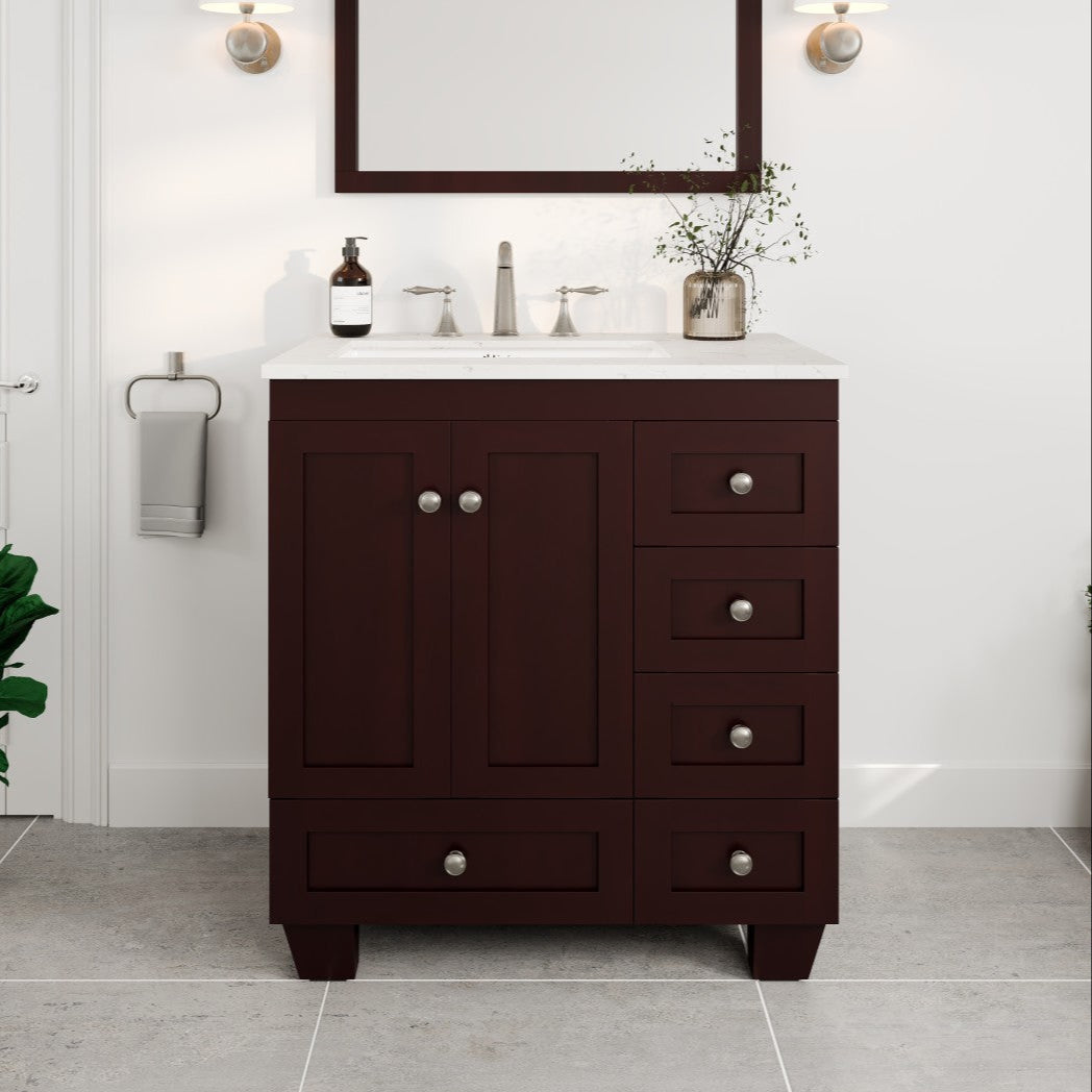 A Teak single sink bath vanity with a Carrara Quartz top and undermount porcelain sink, featuring five drawers and two doors with silver handles.