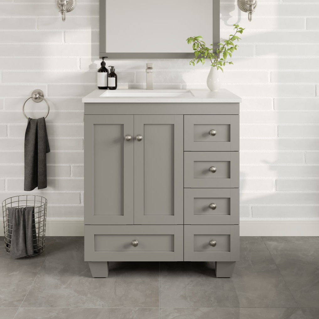 A gray single sink bath vanity with a Carrara quartz top and undermount porcelain sink, featuring five drawers and two doors with a stainless steel brushed nickel hardware.