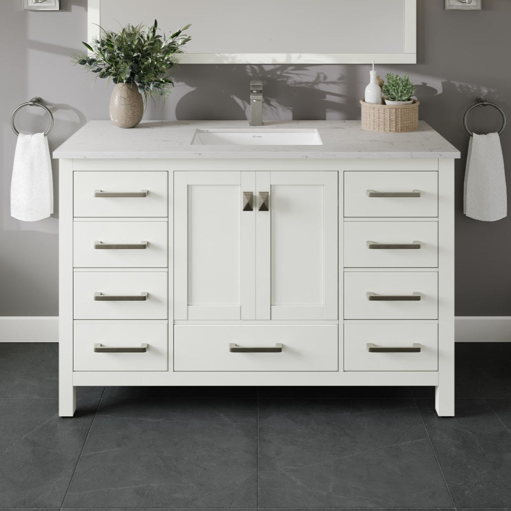 A white single sink bath vanity with a Carrara quartz top and undermount porcelain sink, featuring silver and gold hardware.