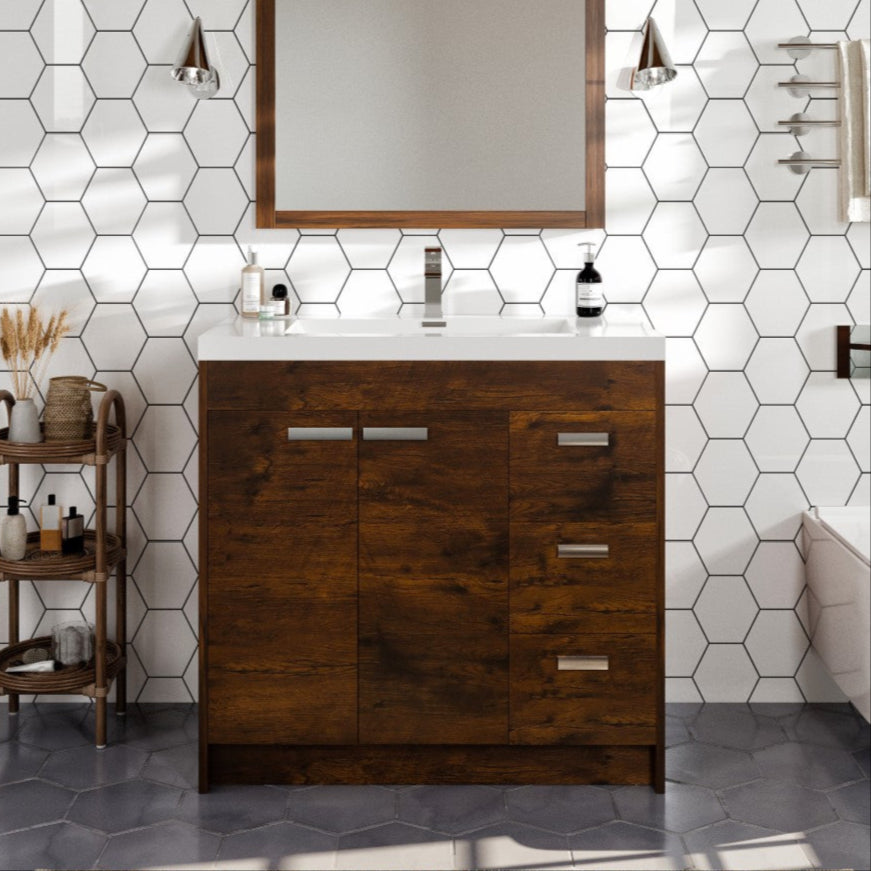 Modern brown rosewood bathroom vanity with an acrylic top and integrated sink, featuring three soft-closing drawers and two soft-closing doors, placed in a bathroom setting with a wall-mounted mirror above it.