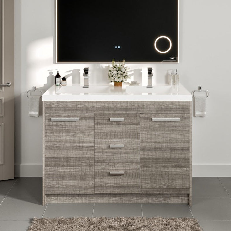 Bathroom vanity with a mirror and various items on a white countertop.