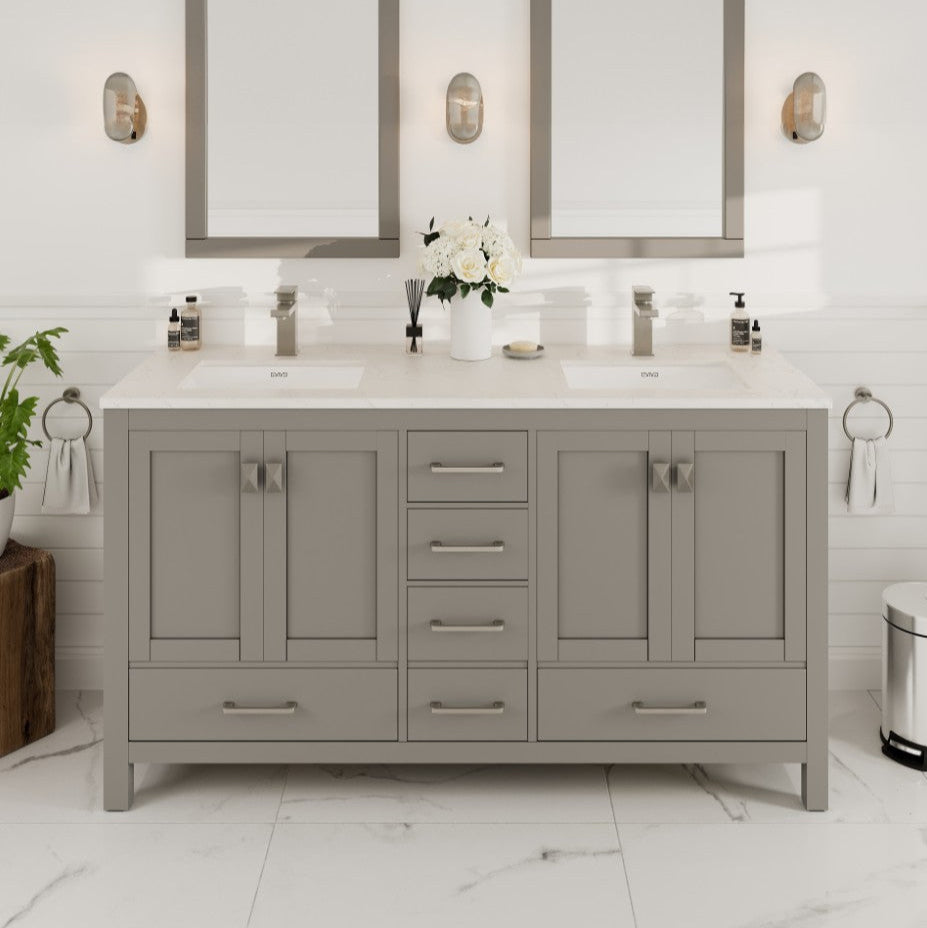A gray double sink bath vanity with a Carrara quartz top, undermount porcelain sinks, and brushed nickel hardware, displayed in a bathroom setting.
