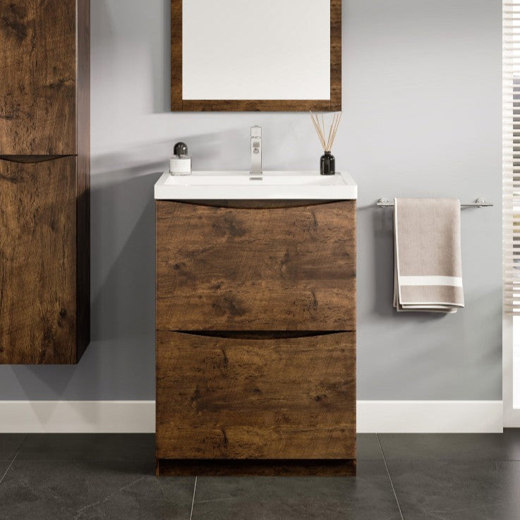 A modern bathroom vanity set featuring a rosewood finish, with two drawers, an integrated sink, and a mirror, set against a gray wall with a plant to the side.