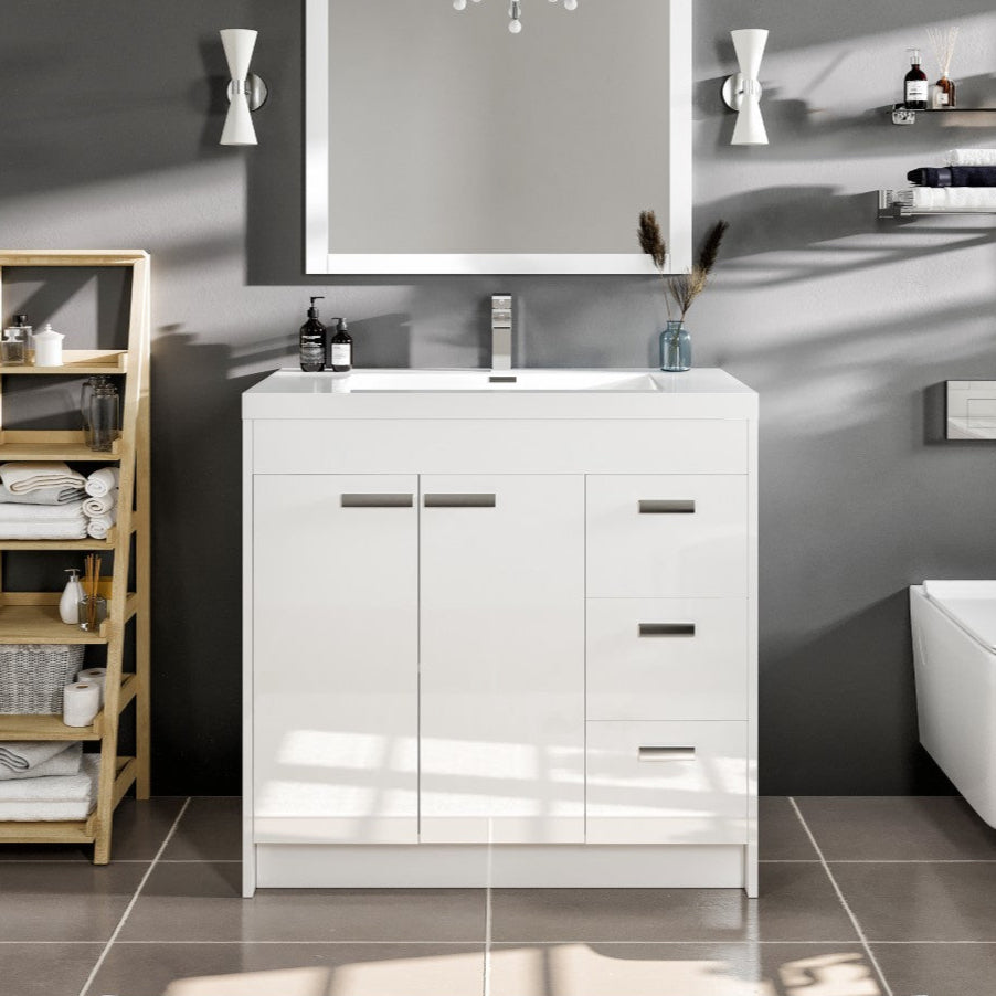 A modern white bathroom vanity with an acrylic top and integrated sink, featuring three soft-closing drawers and two soft-closing doors, set against a gray wall with a wooden ladder and bathroom accessories in the background.