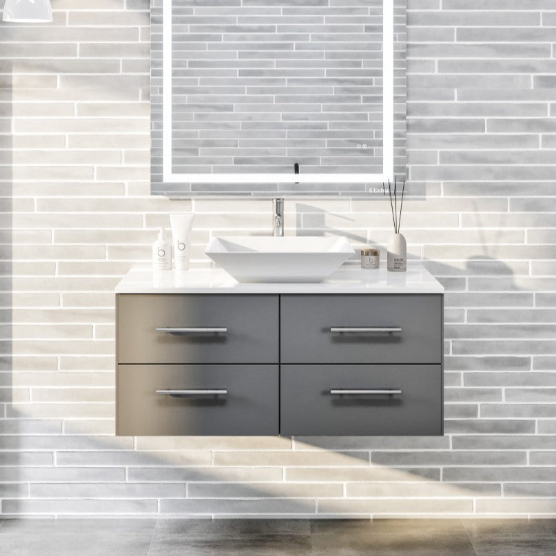 A modern gray wall mount single sink bath vanity with a white quartz top and a vessel porcelain sink, displayed in a bathroom setting with a visible mirror and decorative elements.