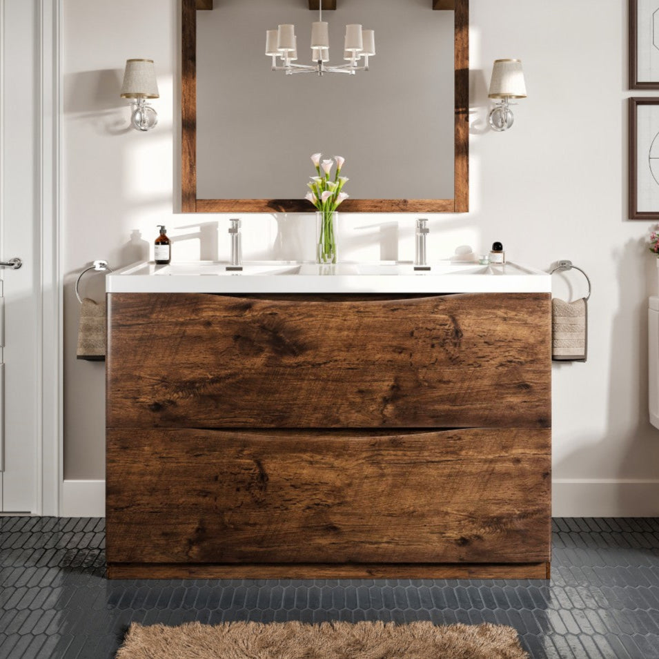 A modern freestanding double sink bathroom vanity with a rosewood finish and an acrylic top, featuring integrated sinks and two soft-closing drawers. The image depicts the vanity in a stylized bathroom setting with decorative items and lighting in the background.
