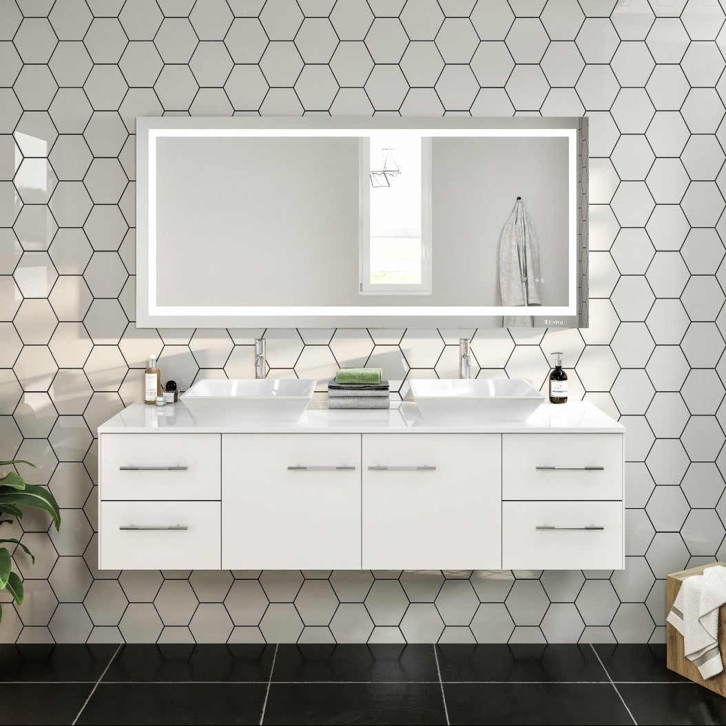 A modern white wall-mounted double sink bathroom vanity with a white quartz countertop and vessel porcelain sinks, featuring a mirror with built-in lighting above it, set against a tiled wall.