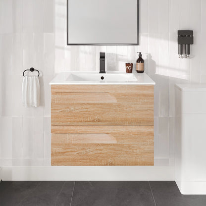 Bathroom vanity with wooden cabinet, sink, and mirror in a tiled bathroom.