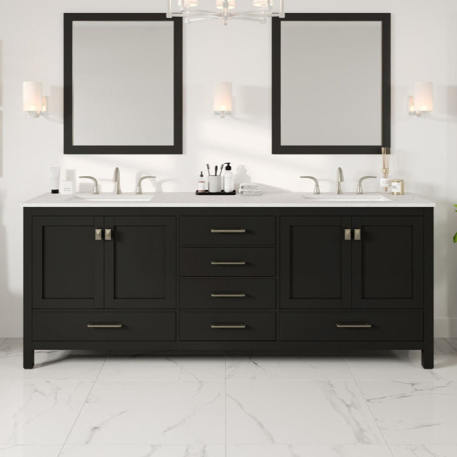 An espresso double sink bath vanity with a Carrara quartz top, undermount porcelain sinks, and gold hardware, displayed in a bathroom setting.