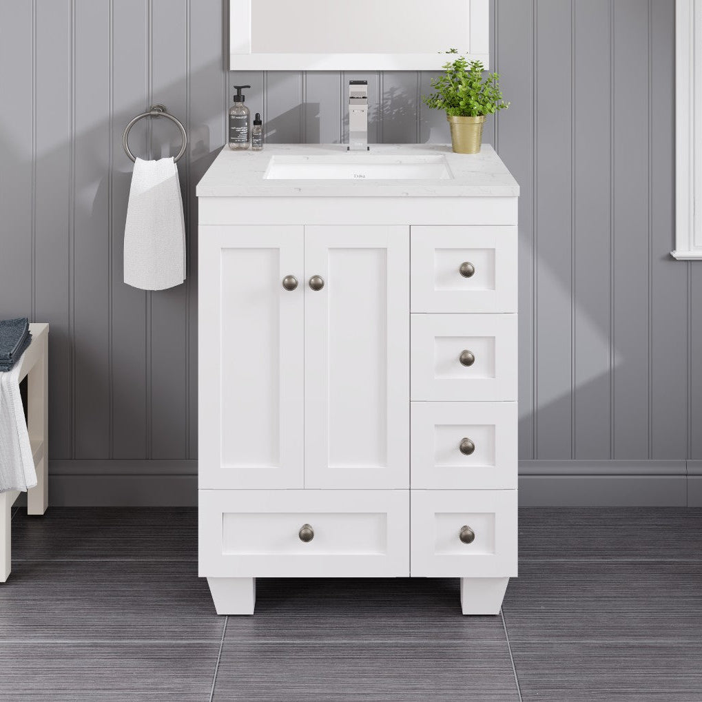 A white single sink bath vanity with a Carrara quartz top and undermount porcelain sink, featuring five drawers and two doors with a premium stainless steel brushed nickel hardware.